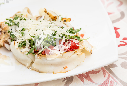 Image of Cuttlefish with tomato, salad and Parmigiano cheese