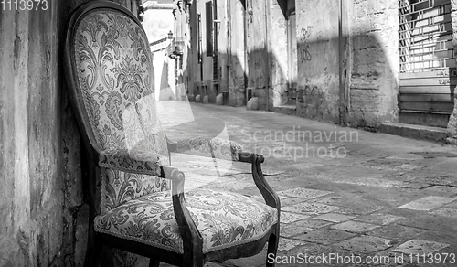 Image of Old chair in a traditional street of Lecce, Italy.