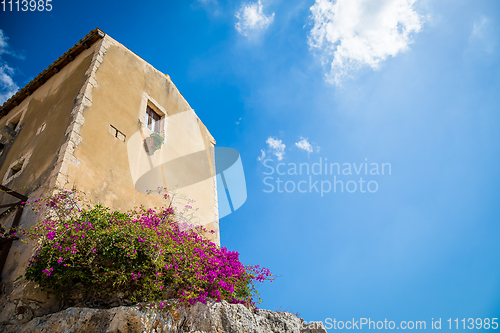 Image of Sicily, Italy. Old house with purple flowers in Syracuse.