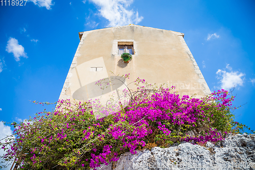 Image of Sicily, Italy. Old house with purple flowers in Syracuse.