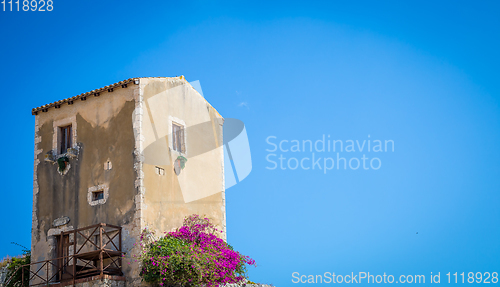 Image of Sicily, Italy. Old house with purple flowers in Syracuse.