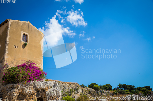 Image of Sicily, Italy. Old house with purple flowers in Syracuse.