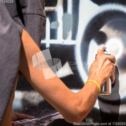 Image of Writer working on a wall in an anonymous way