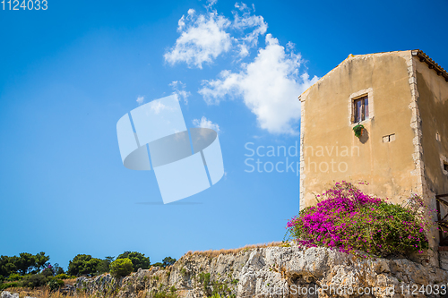 Image of Sicily, Italy. Old house with purple flowers in Syracuse.