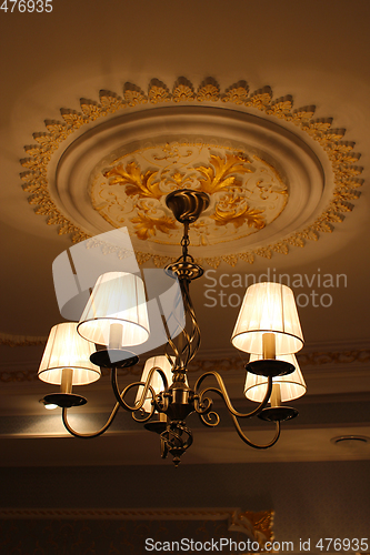 Image of Beautiful sparlking chandelier under the ceiling