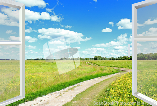 Image of View to clouds meadow and country road from window