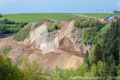 Image of opencast mining quarry with machinery