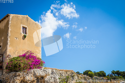 Image of Sicily, Italy. Old house with purple flowers in Syracuse.