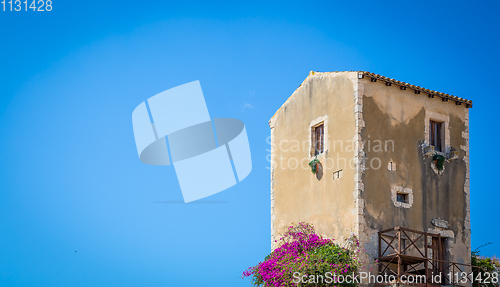 Image of Sicily, Italy. Old house with purple flowers in Syracuse.