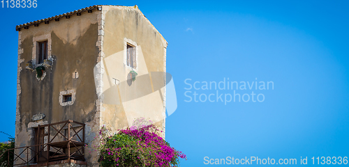 Image of Sicily, Italy. Old house with purple flowers in Syracuse.