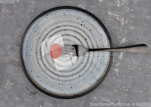 Image of Strawberry on fork and plate