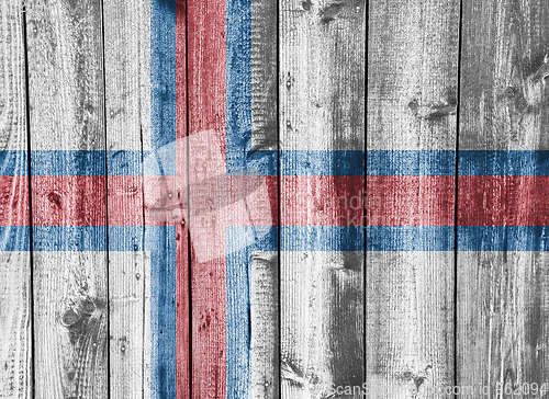 Image of Flag of Faroe Islands on weathered wood