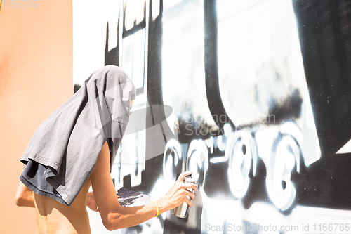 Image of Writer working on a wall in an anonymous way