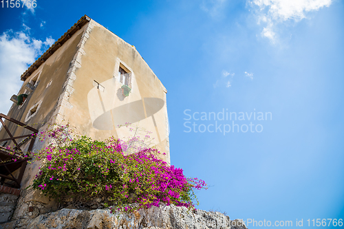 Image of Sicily, Italy. Old house with purple flowers in Syracuse.