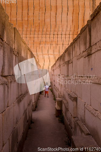 Image of Lonely young boy walking in a corridor