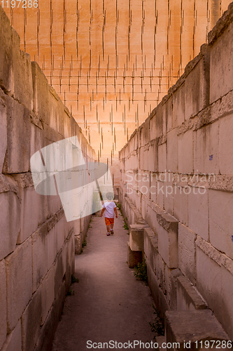 Image of Lonely young boy walking in a corridor