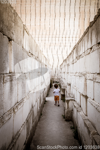 Image of Lonely young boy walking in a corridor