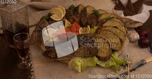 Image of Stuffed pike with vegetables and greens.