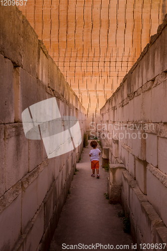 Image of Lonely young boy walking in a corridor