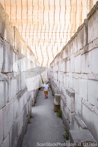 Image of Lonely young boy walking in a corridor