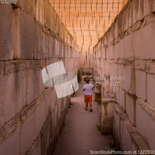 Image of Lonely young boy walking in a corridor