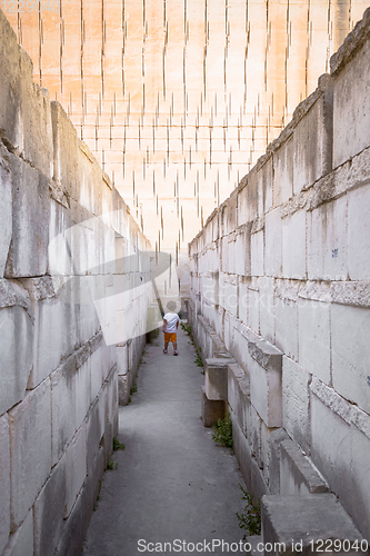 Image of Lonely young boy walking in a corridor