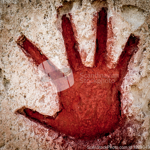 Image of Red hand on stone - graphic gothic element