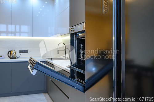 Image of Luxury gray modern kitchen interior, oven\'s door opened