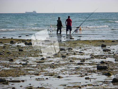 Image of Fishermen on the seashore.