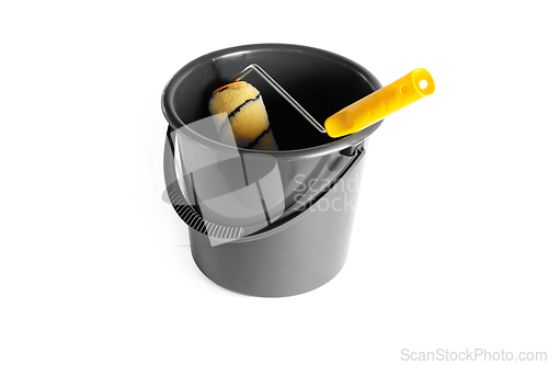Image of Paint roller in a bucket.