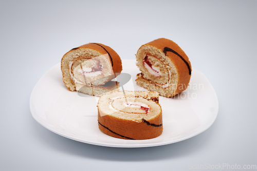 Image of Sliced roll on a plate.