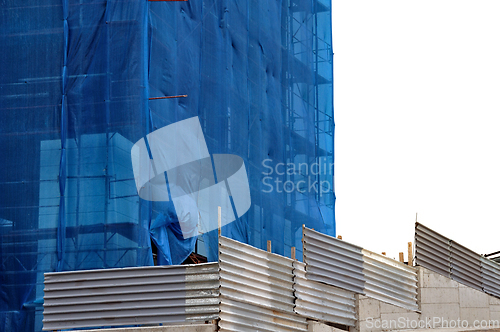 Image of building covered with construction debris netting