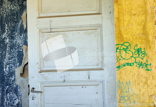 Image of wooden door wallpaper shreds peeling wall