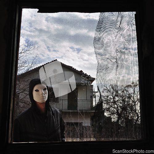 Image of hooded figure threaded window