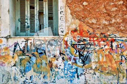 Image of abandoned house wall with messy graffiti