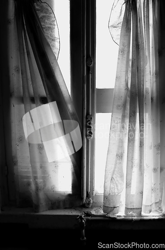 Image of ragged window curtains