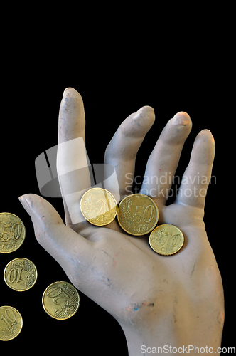 Image of spare change worn hand holding money coins