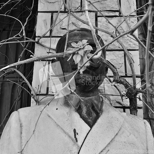 Image of vandalized statue of man with mustache