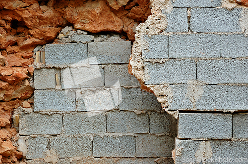 Image of broken stone and cinder block walls