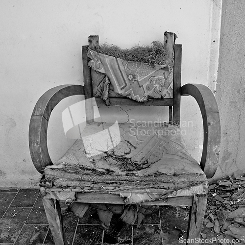 Image of torn armchair and broken glass