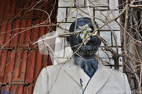 Image of vandalized marble statue of unidentified man