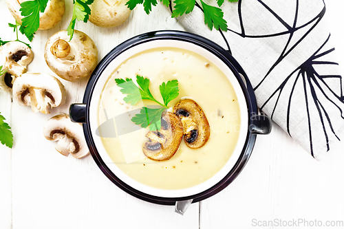 Image of Soup puree of champignon in bowl on board top