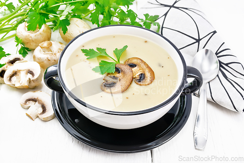 Image of Soup puree of champignon in bowl on board