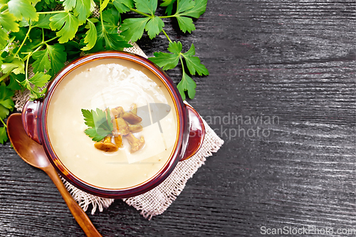 Image of Soup puree of chanterelle in bowl on dark board top