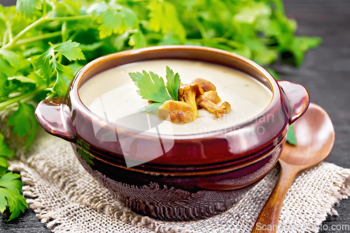 Image of Soup puree of chanterelle in bowl on dark board