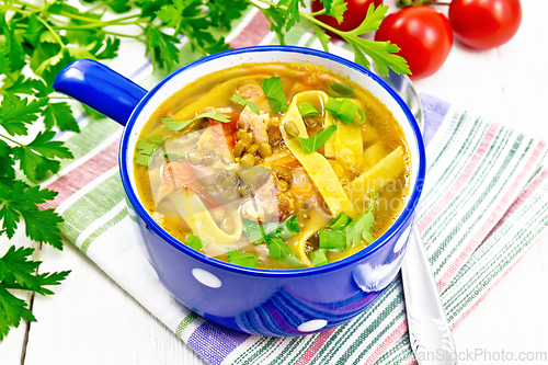 Image of Soup with mung and noodles in blue bowl on white board