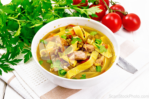 Image of Soup with mung and noodles in bowl on board