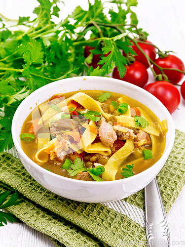 Image of Soup with mung and noodles in bowl on towel