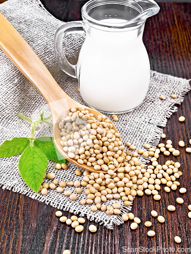 Image of Soybeans in spoon with milk on wooden board