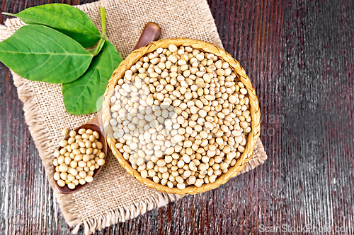 Image of Soybeans in wicker bowl with leaf on board top